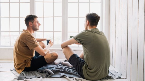 young male friends talking with morning coffee