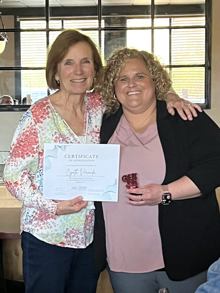 Volunteer Cynthia Veronda holds a certificate of appreciation and poses with Brittany Fry, the Director of Volunteer Services